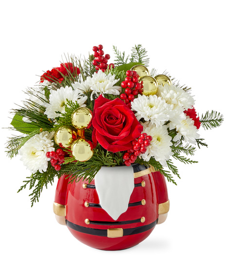 Christmas flowers arranged in a nutcracker vase