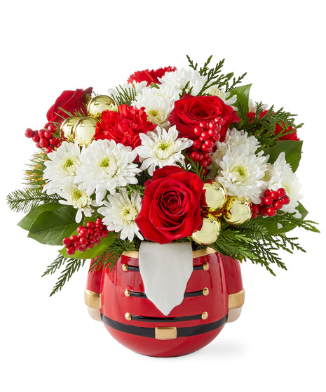 Christmas flowers arranged in a nutcracker vase