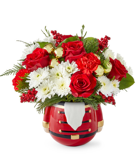 Christmas flowers arranged in a nutcracker vase