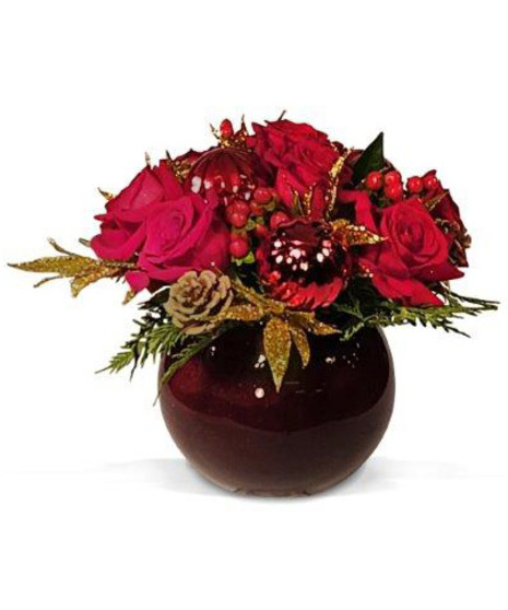 Red rose arrangement designed inside round red vase