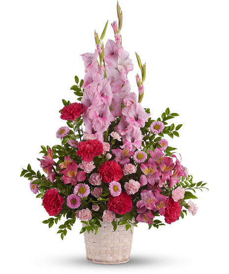 Pink sympathy flowers in a white basket