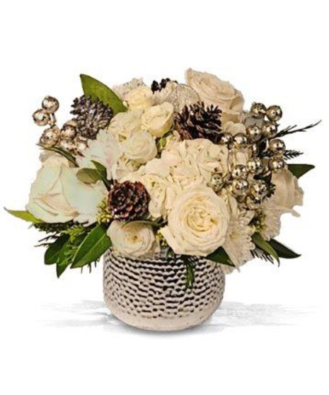 white holiday arrangement inside silver ceramic pot