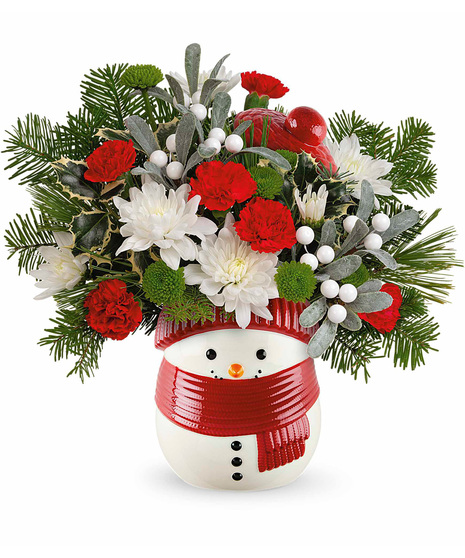 Christmas flowers arranged in a snowman vase. The Frosty Wishes Treat Jar.