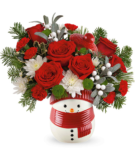 Christmas flowers arranged in a snowman vase. The Frosty Wishes Treat Jar.