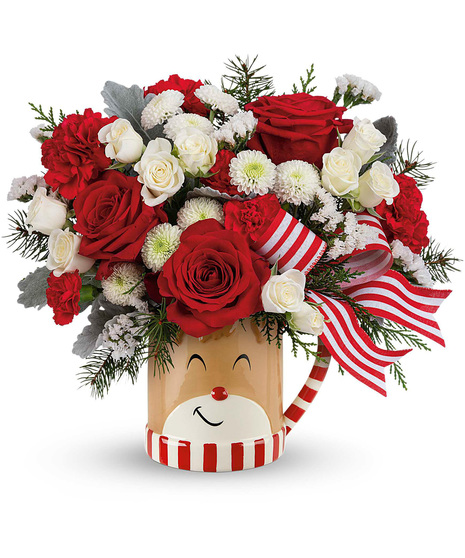 Christmas blooms arranged in a Reindeer wish mug