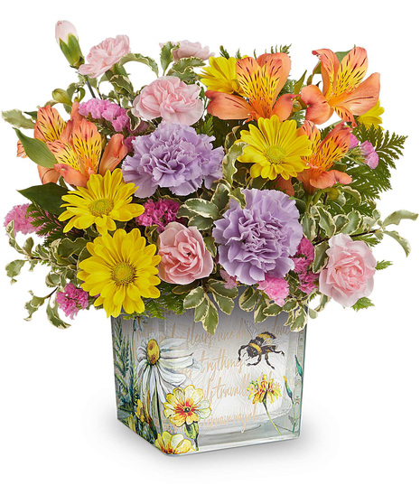 Floral Buzz Bouquet with orange alstroemeria, lavender carnations, yellow daisies, and pink blooms in a vintage inspired glass cube vase.