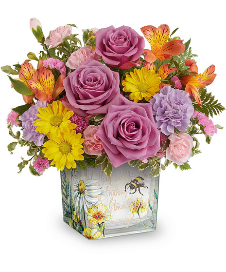 Floral Buzz Bouquet with orange alstroemeria, lavender carnations, yellow daisies, and pink blooms in a vintage inspired glass cube vase.