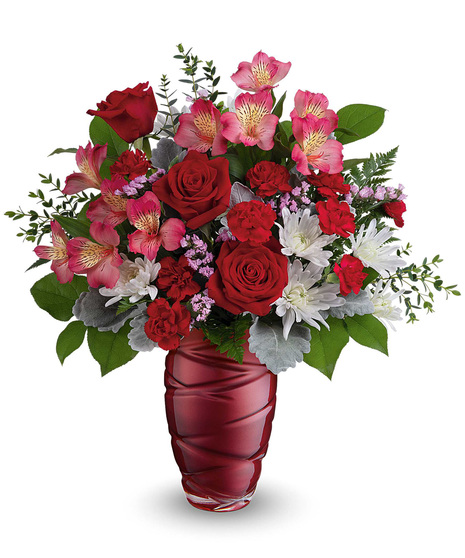 Elegant red vase with red roses, white chrysanthemums and more beautiful flowers.