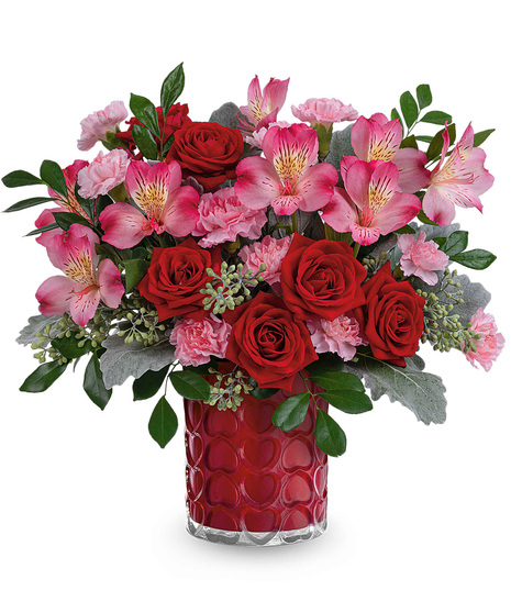 Red, pink and green arrangement designed in vase covered in hearts.