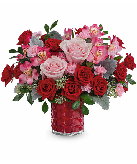 Red, pink and green arrangement designed in vase covered in hearts.