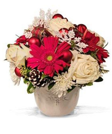 Red and white Christmas arrangement in a white ceramic pot with snowflake