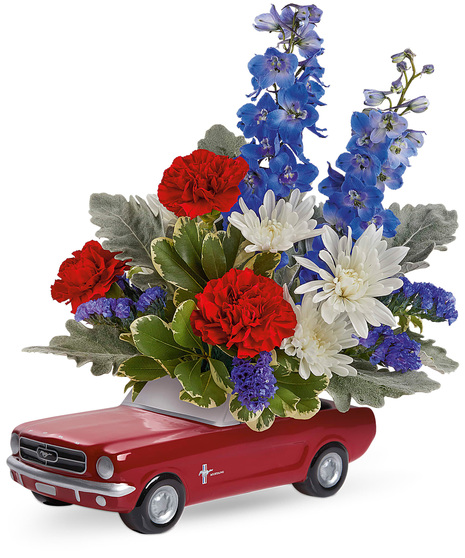 Red, white and blue flowers in a 1965 Ford Mustang Keepsake