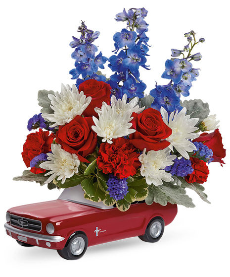 Red, white and blue flowers in a 1965 Ford Mustang Keepsake